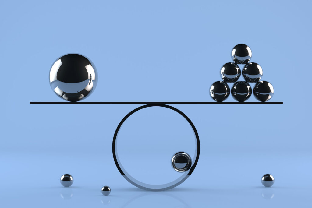 Balance board on blue background with chrome spheres and reflections.